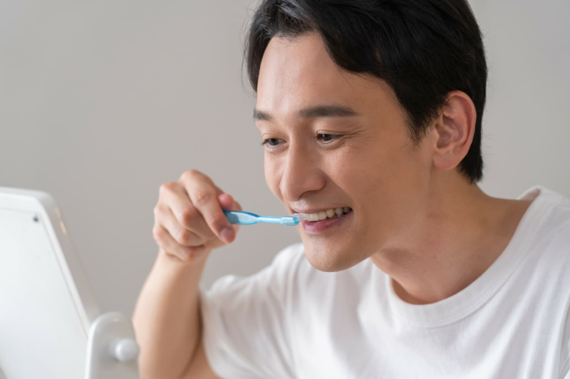 歯周病を予防するために歯磨きをする男性
